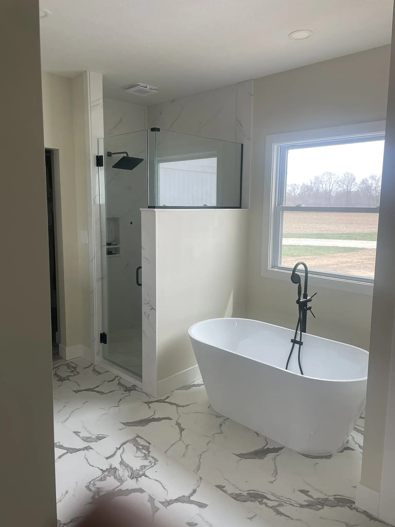 Bathroom with freestanding bathtub and shower area