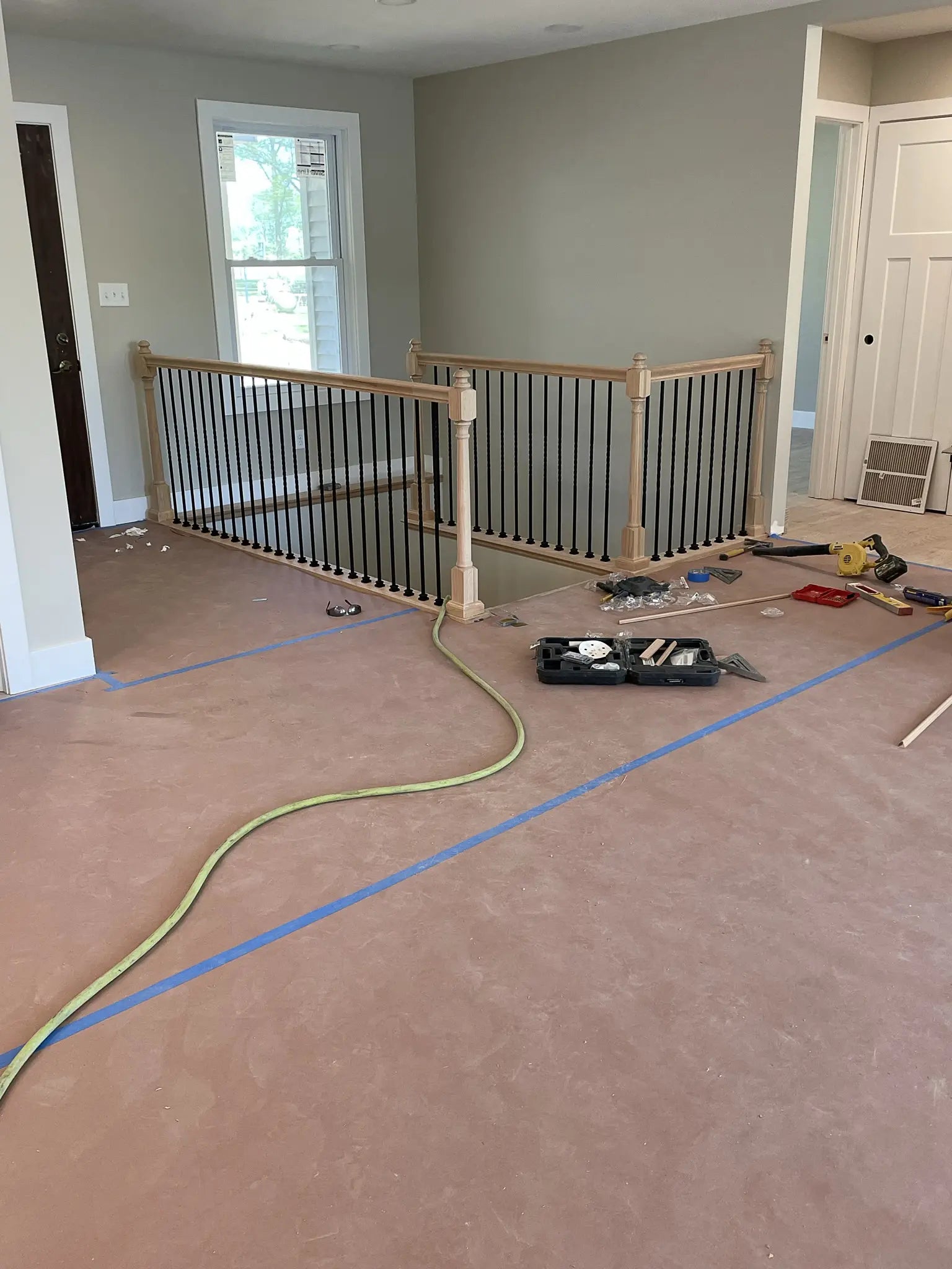 Room under construction with a staircase and tools on the floor