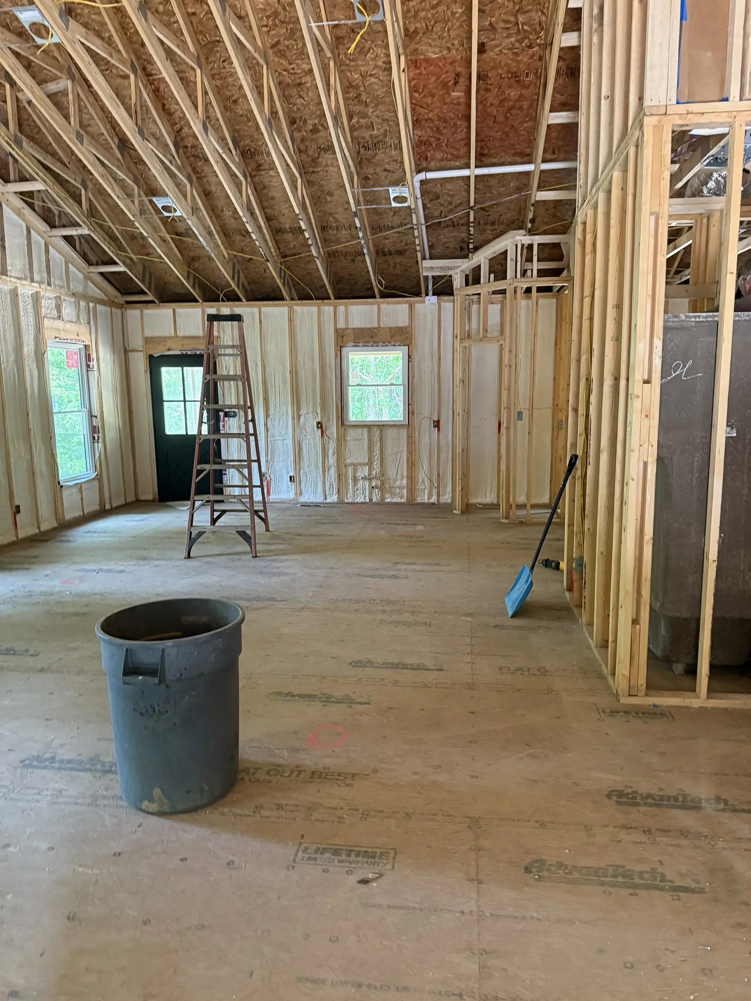 Under construction room with wooden framing and a ladder.