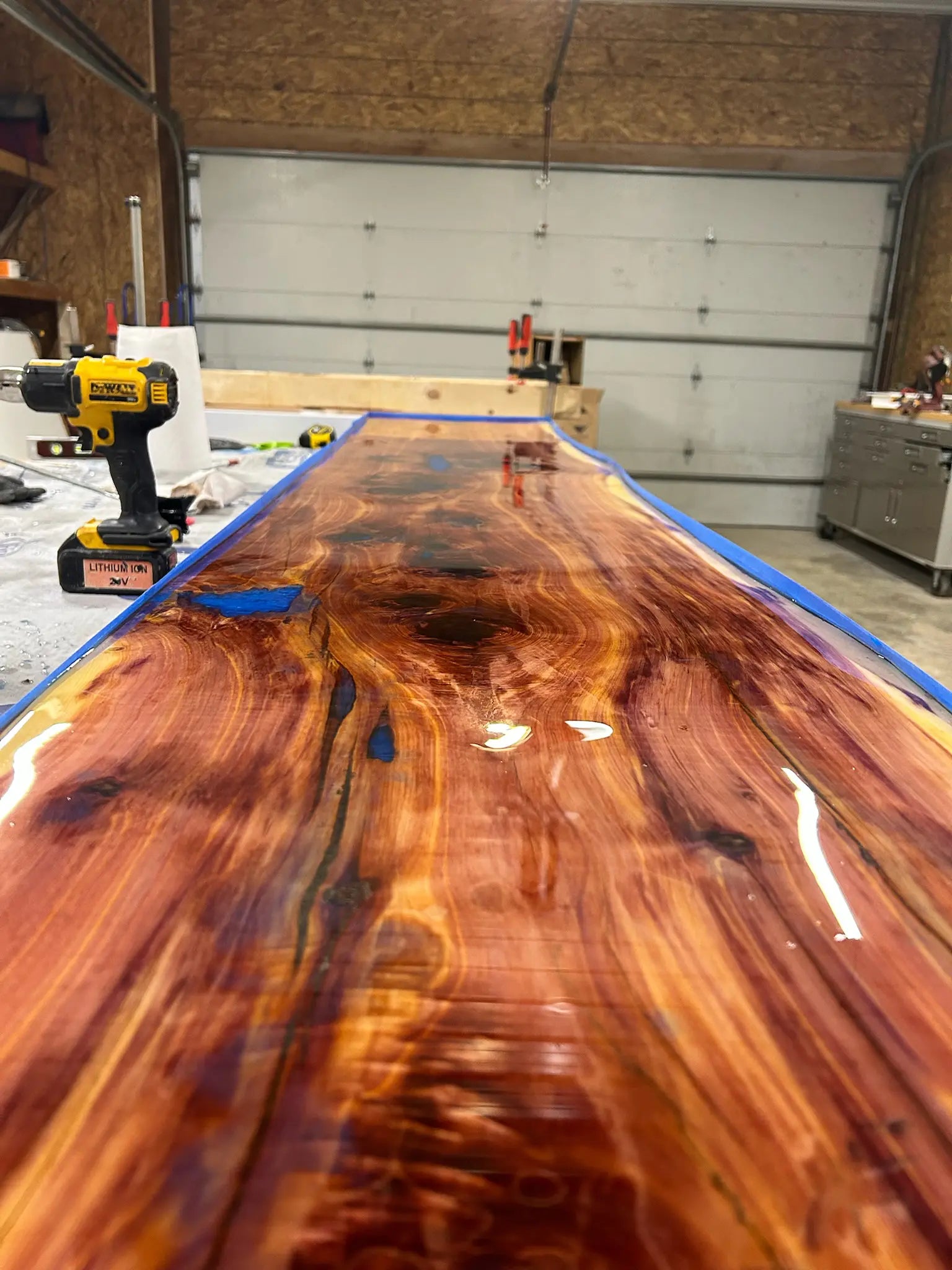 Wooden epoxy resin bar top with a glossy finish in a workshop setting