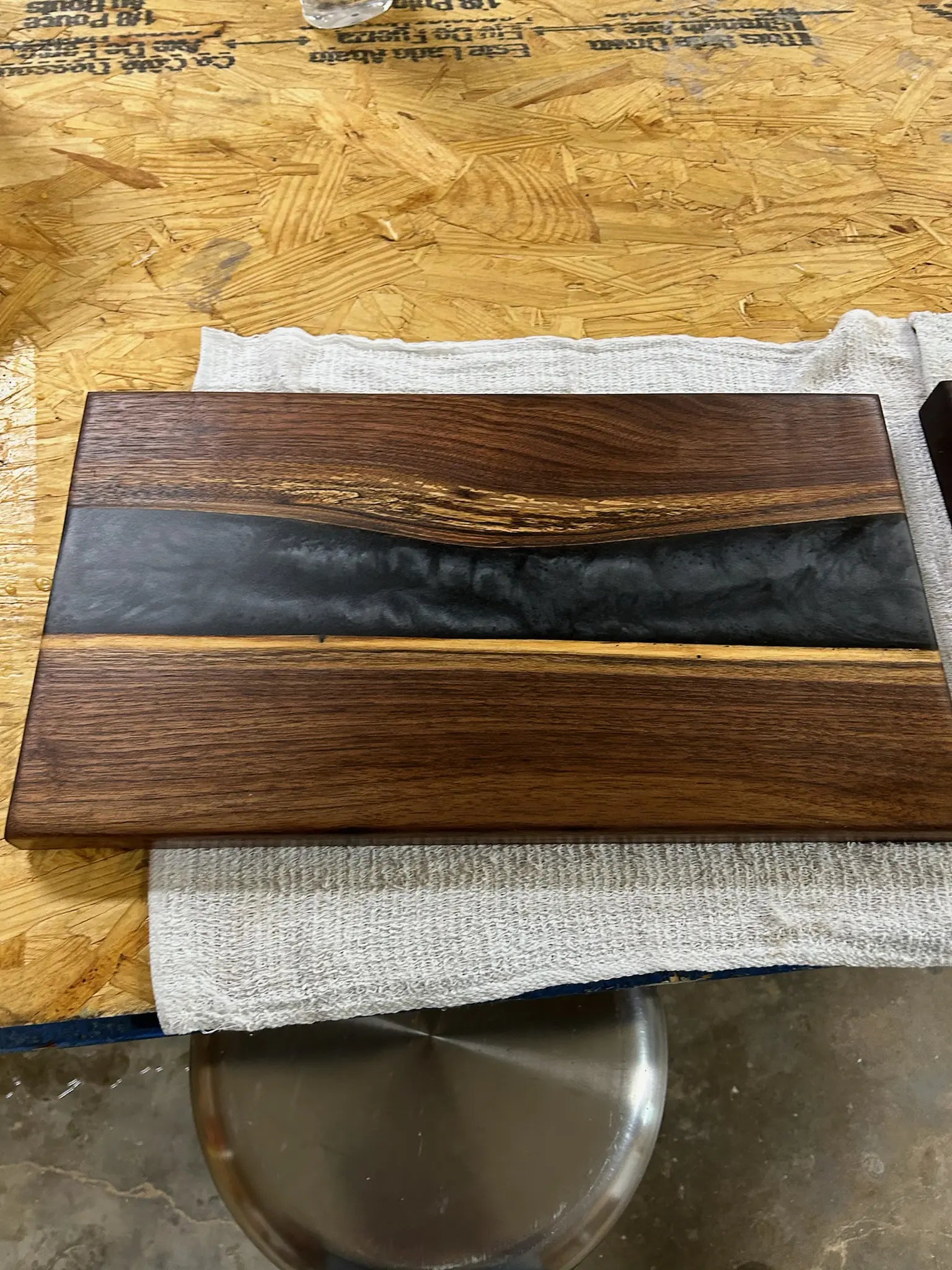 walnut wood serving tray with black epoxy resin river