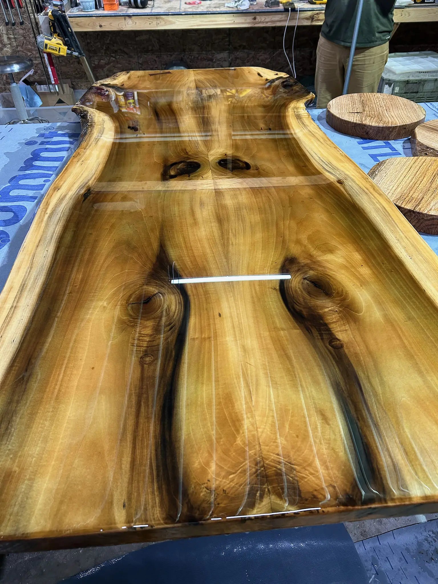 Wooden table with a natural finish on a workshop floor